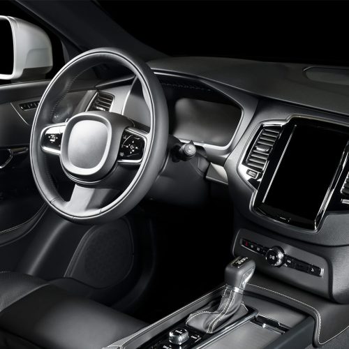 Steering wheel, dashboard, and seating area of a car interior