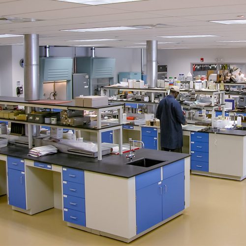 Man in lab coat working in a chemistry lab, conduction R&D to develop medical applications of specialty films and coatings.