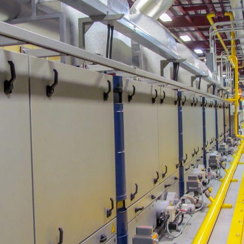 Long, nondescript machine that produces synthetic leathers and suedes for footwear uppers and components, accessories and performance gear, car upholstery and interior elements, and specialty consumer and lifestyle products.