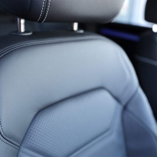 Dark synthetic leather car seat.